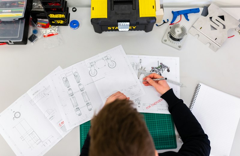 Engineering student working on technical drawings