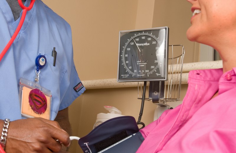 Nurse checking a patient's blood pressure